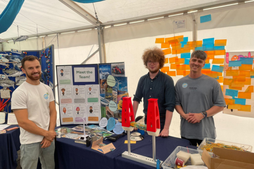 Men stood by Meet the Team stall at Festival of Nature
